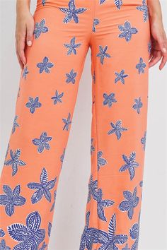 Stretch waistband floral print wide leg pants. Printed Wide Leg Pants For Spring Loungewear, Wide Leg Floral Print Loungewear Bottoms, Orange Printed Wide Leg Bottoms, Printed Wide Leg Orange Bottoms, Spring Floral Print Wide Leg Loungewear Pants, Spring Floral Print Wide Leg Pants For Loungewear, Floral Print Wide Leg Loungewear Pants, Floral Print Wide-leg Loungewear Pants, Wide Leg Floral Print Lounge Pants