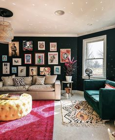 a living room filled with lots of furniture and pictures on the wall next to a window