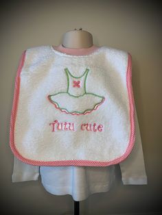 Made of thick, thirsty, & very absorbent terry cloth, this kind of bib is every parent's favorite. It pops right over child's head like a t-shirt - no snaps, velcro, or ties to get in the way. Machine embroidered design makes for long lasting color. Finished bib is approximately 19 x 12 inches. Neckline should fit 6 months to 3 years. Easy care machine wash and dry. Makes a great, unique shower or baby gift. PLEASE NOTE; COLOR OF BINDING MAY VARY FROM PICTURE. Cute White Bib Front Bib, Cute White Bib For Playtime, White Washable Cotton Bib, Cute Machine Washable Bibs For Playtime, White Cotton Washable Bib, Cute Cotton Washable Bib, Playful White Machine Washable Bib, Pink Cotton Bib Machine Washable, Playful White Cotton Bib