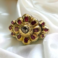 Georgian Era Iberian Ruby and Rose Cut Diamond Ring in 18-22K Gold What is Iberian jewelry? Iberian jewelry refers to jewelry that is inspired by or originates from the Iberian Peninsula, which includes Spain and Portugal.  It often incorporates elements of traditional Iberian culture, such as intricate designs, symbolic motifs, and the use of precious gemstones like rubies and diamonds. Iberian jewelry is renowned for its elegance, craftsmanship, and historical significance, reflecting the rich Ornate Baroque Jewelry With Rose Cut Diamonds, Baroque Rose Cut Diamond Gold Jewelry, Baroque Gold Jewelry With Rose Cut Diamonds, Gold Baroque Jewelry With Rose Cut Diamonds, Traditional Ceremonial Ruby Rings, Traditional Ruby Rings For Ceremonial Occasions, Ornate Ceremonial Jewelry With Rose Cut Diamonds, Victorian Jewelry With Rose Cut Diamonds For Ceremonial Occasions, Yellow Gold Ring With Historical Design