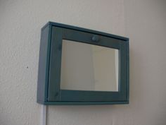 a mirror mounted to the side of a wall