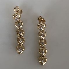 These are adorable heart drop earrings with diamonds set in each little heart. They have a sturdy pushback closing and are not super heavy on the ear. The are slightly over 1 inch in length. They weigh 4.16 grams total weight. The diamonds weight approximately.08ct total. With any pre-owned/Vintage/Antique items, it is common to have some wear, As we inspect each piece of our jewelry, we make sure the wear and tear is acceptable within industry standards FOLLOW US TO SEE MORE PHOTOS OF OUR JEWEL Vintage Heart Charm Earrings For Anniversary, Vintage Gold Heart Dangle Earrings, Vintage Gold Heart Earrings For Valentine's Day, Vintage Heart Charm Earrings For Valentine's Day, Valentine's Day Heart-shaped Diamond Earrings, Gold Bar Earrings, Diamond Dangle Earrings, Heart Drop Earrings, Diamond Anniversary