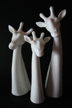 three ceramic giraffes standing next to each other