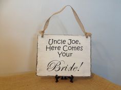 a sign that says uncle joe, here comes your bride on the back of a chair