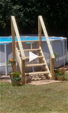 an above ground swimming pool with steps leading up to it and potted plants in the foreground