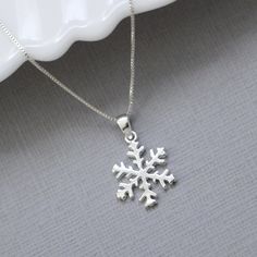 Sterling silver snowflake pendant on fine sterling silver necklace chain, bridesmaid gift OTHER SNOWFLAKE JEWELRY IN THE STORE: https://www.etsy.com/shop/alexandreasjewels/search?search_query=snowflake Snowflake size: 14mm Also available at 18mm in listing below: https://www.etsy.com/listing/205447671/snowflake-necklace-sterling-silver ADD-ON CHARMS: https://www.etsy.com/listing/205430600/add-a-charm-personalize-your-jewelry?ref=listing-shop-header-0 COMES CAREFULLY AND BEAUTIFULLY GIFT PACKAGED Elegant Winter Jewelry As Gift, Silver Snowflake Necklace For Anniversary, Silver Snowflake Necklace For Holiday, Silver Jewelry Christmas Gift For Her, Sterling Silver Snowflake Jewelry For Anniversary, Sterling Silver Necklaces For Winter Gifts, Silver Necklaces For Winter Holidays, Round Jewelry Gift For Winter, Silver Jewelry As Winter Gift