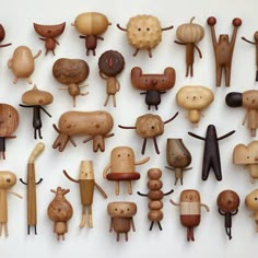 many wooden toys are arranged on a white surface