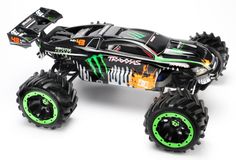 the monster truck is painted black and green