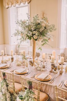 an elegant table setting with candles and flowers