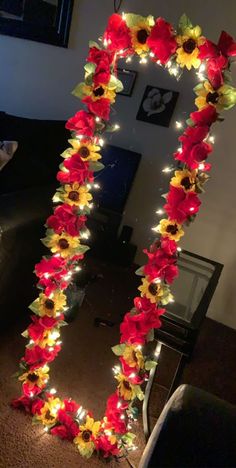 a mirror decorated with flowers and lights in the shape of a flower frame on a carpeted floor