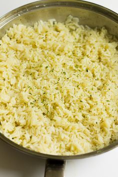 a pan filled with rice sitting on top of a stove