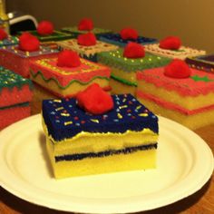 a piece of cake sitting on top of a white plate next to other pieces of cake