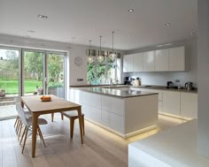 an open kitchen and dining room with sliding glass doors