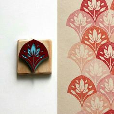 a rubber stamp with a red and blue design on it next to a wallpaper