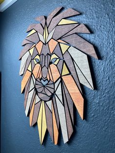 a wooden cutout of a lion's head on a blue wall