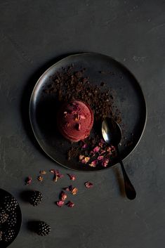 a plate that has some kind of dessert on it with spoons next to it