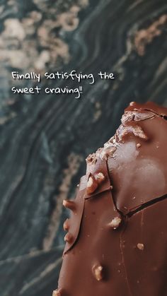 a piece of chocolate cake sitting on top of a table next to a quote that reads, finally satisfieding the sweet carving