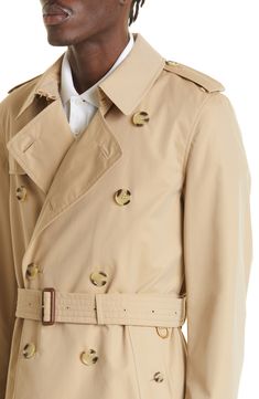 A classic double-breasted silhouette defines this mid-length trench crafted in the UK from water-repellent cotton gabardine and styled with a removable belt. 39" length (size 50EU) Double-breasted button closure Notched lapels with hook-and-eye throat latch Belted cuffs Front button-welt pockets Gun flap Storm flap Back vent Removable belt Check-print lining 100% cotton Dry clean Made in the UK Men's Designer Clothing Classic Cotton Outerwear With Double-breasted Button, Classic Cotton Outerwear With Double-breasted Button Fastening, Classic Gabardine Pea Coat For Spring, Classic Spring Pea Coat In Gabardine, Classic Gabardine Pea Coat With Hidden Buttons, Classic Gabardine Pea Coat With Button Closure, Classic Gabardine Outerwear With Double-breasted Fastening, Classic Double-breasted Gabardine Outerwear, Classic Double-breasted Outerwear With Belted Cuffs