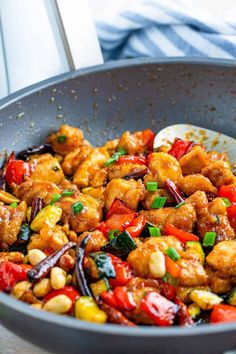 a pan filled with chicken and vegetables on top of a table