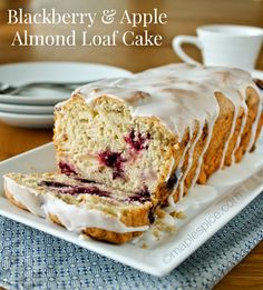 a loaf of blackberry and apple almond loaf cake on a plate