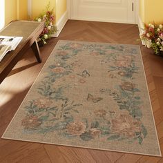 a rug with flowers on the floor in front of a door