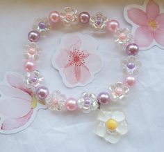 So sweet faux pearl and daisy bracelet in pastel purple and pink. Cheery white daisy charm detatches. This is a unique, handcrafted item. It is lightweight and easy to wear and sized for bigger kids and young at heart adults. 7 inches unstretched. Pink And Lavender, Daisy Charm, Daisy Bracelet, Rose Pastel, White Daisy, Pastel Purple, Plastic Beads, Beaded Stretch Bracelet, So Sweet