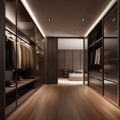 a walk in closet with wooden flooring and glass doors leading to the bed area