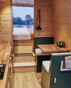 the interior of a small cabin with wood paneling and green accents on the walls