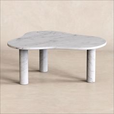 a white marble coffee table with two legs