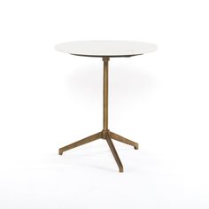 a white table with wooden legs and a round top, on a white background in front of the camera