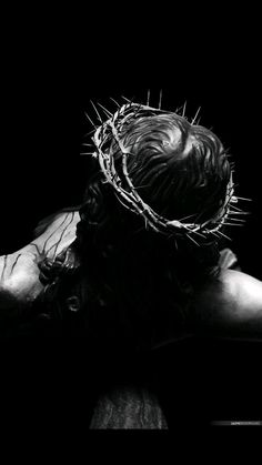 black and white photograph of jesus with crown of thorns on his head in the dark