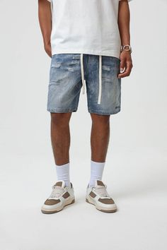 Bring an edgy touch to your casual wear with the Contrast Texture Ripped Denim Shorts. This pair is thoughtfully ripped throughout, adding a grungy twist to the classic washed blue color. With an elastic waistband design, which is highly unusual for denim shorts, you get the benefit of both style and comfort. The extended drawstrings allow for a customizable fit, adding to the unique appeal of these must-have shorts. Ripped throughout for a grungy aesthetic Classic washed blue color Elastic wais Contrast Texture, Shorts Ripped, Waistband Design, Ripped Denim Shorts, Ripped Denim, The Hundreds, Male Model, Must Haves, Casual Wear