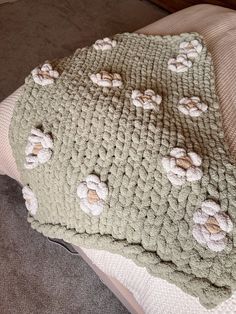 there is a crocheted blanket with flowers on it