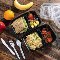 three plastic containers filled with food on top of a wooden table next to fruit and vegetables