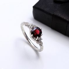 RING DETAIL Metal : 925 sterling silver Center stone : Garnet size of stone : 7mm shape : Round About gems stone GARNET . Garnet have exceptional characteristics to satisfy a wide range of vigorous needs--from improving one's essentialness and wellbeing to insurance from pessimism. Since it's such a stimulating stone, garnet is regularly utilized for appearance purposes and worn as a charm for best of luck. Notwithstanding bringing essentialness, high energy, and insurance, garnet additionally h Garnet Open Ring Promise Ring, Garnet Open Ring For Anniversary, Garnet Ring With Prong Setting, White Gold Garnet Jewelry For Promise Ring, Garnet Rings In White Gold For Gifts, Garnet White Gold Rings For Gift, Silver Garnet Solitaire Ring, Silver Garnet Ring With Prong Setting, White Gold Garnet Ring For Gift