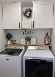 a white washer and dryer sitting next to each other in a laundry room