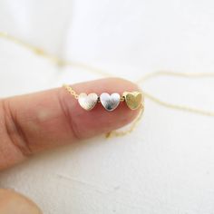 "Beautiful and lovely dainty hearts charm necklace. Made of brushed surfaced multi color( rose gold, gold and silver ) tiny 3 hearts charm withs skinny gold chain. Soft and simple. Great for gift , everyday or special occasion. Your item will ship in a gift box. Please feel free to contact me if you have any question. ♥ Chain length 14\" - 20\" ♥ Gold Chain ♥ Three Hearts 3/4\" x 1/4 '' ♥ Rose gold, gold and rhodium plated over brass ♥ See more Rudiana Accessories Rudiana.etsy.com" Dainty Rose Gold Heart Beads Necklace, Dainty Double Heart Rose Gold Necklace, Dainty Double Heart Necklace For Mom, Small Heart Necklace, 3 Hearts, Sister Necklace, Hearts Necklace, Gold Butterfly, Jewelry Stand