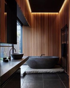 a large bath tub sitting next to a wooden wall