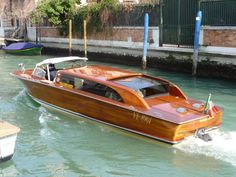 a small wooden boat traveling down a canal