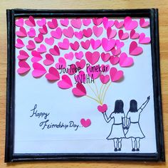 two girls holding hands with pink hearts in the shape of heart balloons on a white and black frame