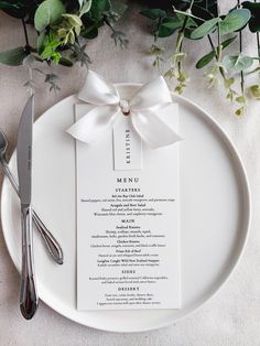 a white plate topped with a menu and silverware