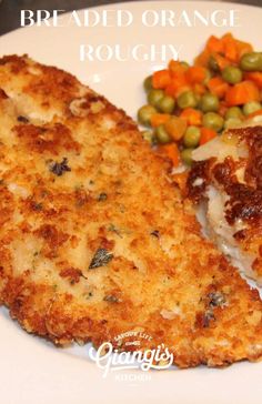 a white plate topped with meat and veggies next to breaded orange rougy