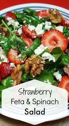 strawberries, feta and spinach salad on a plate with the words strawberry feta & spinach salad