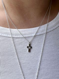 Embrace the timeless elegance and spiritual significance of our small silver cross  necklace. Meticulously crafted for both style and sentiment, this dainty necklace is the perfect accessory for everyday wear or special occasions. Product Features: 🌟Elegant Design: The cross pendant, a universal symbol of faith and hope, is elegantly crafted in high-quality plated sterling silver. The sleek and minimalist design ensures it complements any outfit, from casual to formal. 🌟 Perfect Length: The pendant is suspended on an 18'' sterling silver chain, providing a flattering length that sits gracefully on the collarbone. This versatile length is ideal for layering with other necklaces or wearing on its own. 🌟 Quality Material: Made from sterling silver plated chain, this necklace is hypoallerge Minimalist Cross Pendant Necklace For Everyday, Minimalist Cross Pendant Necklace For Everyday Wear, Dainty Cross Necklace For Everyday Wear, Silver Cross Pendant Necklace For Everyday, Silver Necklace With Delicate Chain And Cross Pendant, Sterling Silver Necklace With Delicate Cross Pendant, Minimalist Cross Necklace For Everyday, Dainty Silver Crucifix Necklace, Minimalist Sterling Silver Cross Necklace With Clavicle Chain