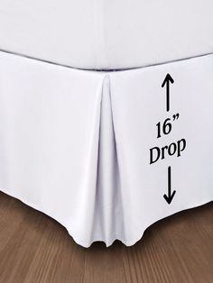 a white bed skirt with an arrow pointing to the 10'drop and two black arrows on it