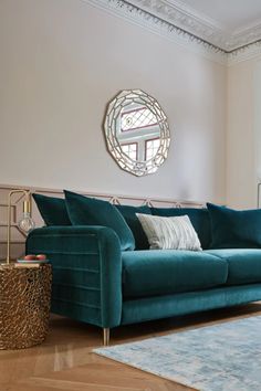 a living room with a blue couch and rug