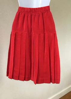 "This 90's red silk skirt is so much more than what the photos  show! It's truly beautiful with the drop hip detail and impeccable pleating! It's lined and has an elastic waistband. Eye catching color, beautifully tailored, and easy to wear. Great vintage condition with no issues!  No size tag but measures small. Measured flat. Waist,26 1/2\"    Stretches to 30\" Hips, 40\" Length,20\"" Silk Skirt, Red Silk, Pleated Mini Skirt, Elastic, Womens Skirt, Mini Skirts, Art Collection, Silk, Bathing Beauties