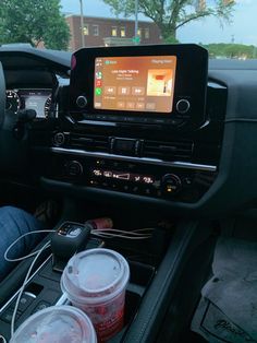 the interior of a car with an entertainment system in the center and two buckets on the dash