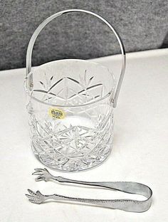 an empty glass basket with a metal spoon next to it