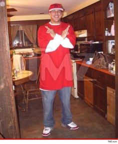 a man standing in a kitchen with his arms crossed